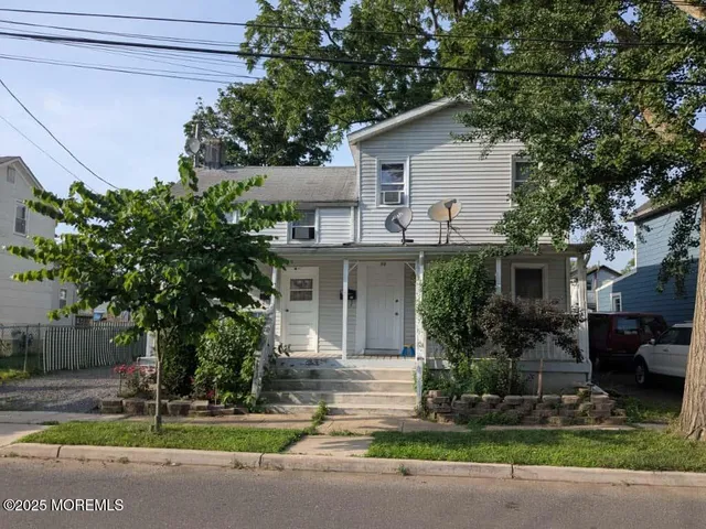 a house that has a tree in front of it