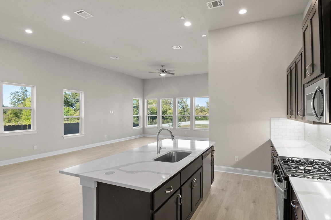 600 C-Bar Ranch Trail, Unit 122 Cedar Park, TX 78613 - Photo 18 of 31 a kitchen with granite countertop a sink and a window