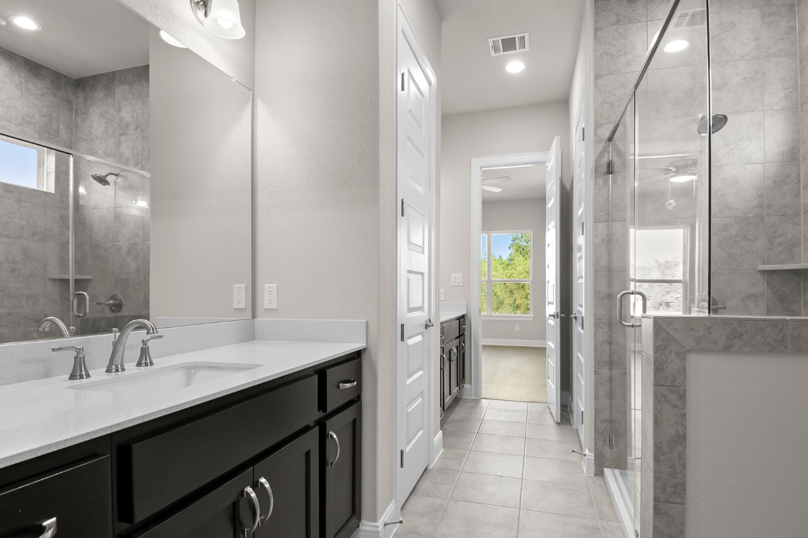 600 C-Bar Ranch Trail, Unit 122 Cedar Park, TX 78613 - Photo 28 of 31 a bathroom with a double vanity sink a toilet and a shower