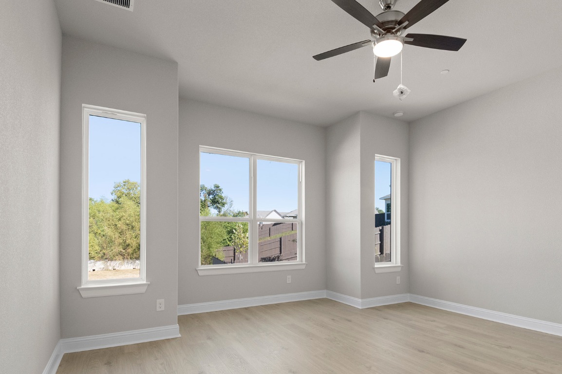 600 C-Bar Ranch Trail, Unit 122 Cedar Park, TX 78613 - Photo 29 of 31 an empty room with windows and ceiling fan