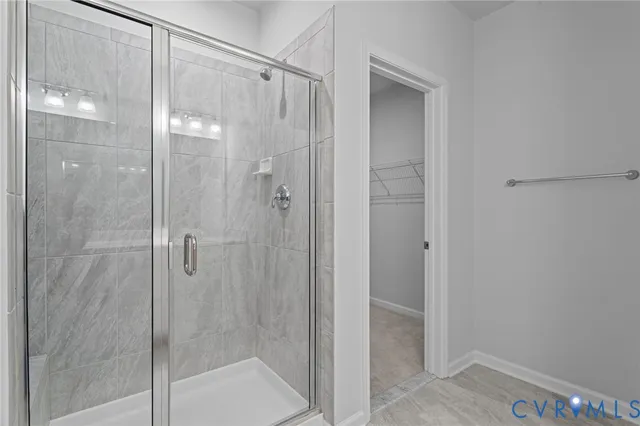 a bathroom with a glass shower door