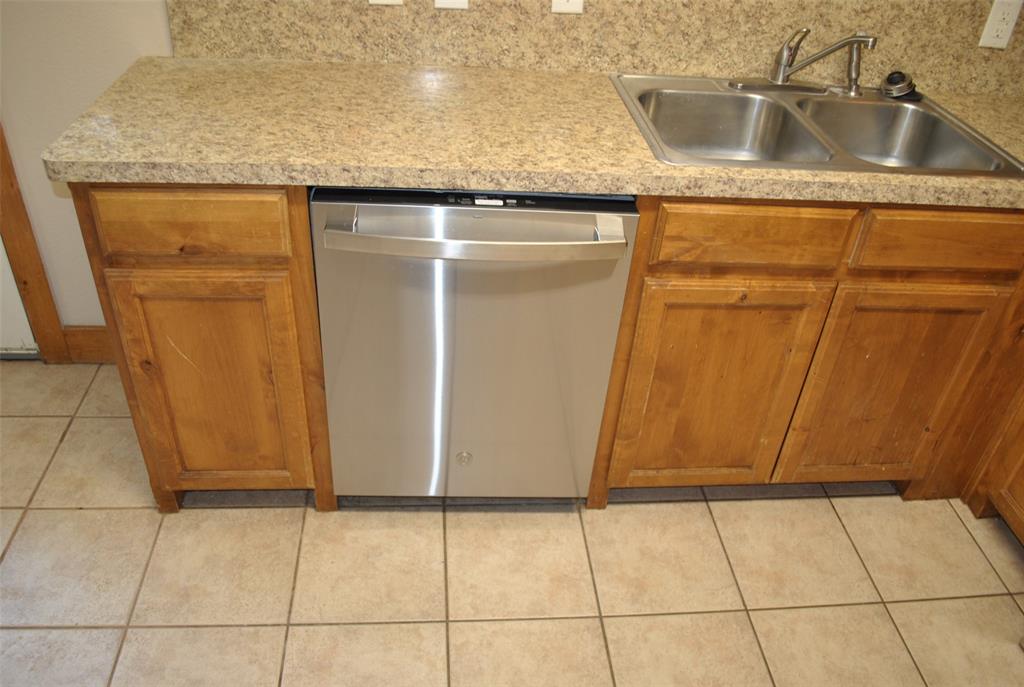 515 East Liberty Street Pilot Point, TX 76258 - Photo 16 of 25 a bathroom with a granite countertop sink and a mirror