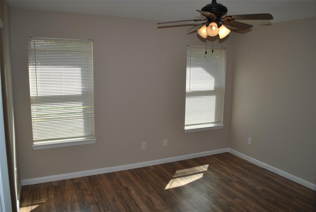 515 East Liberty Street Pilot Point, TX 76258 - Photo 20 of 25 a view of a room with wooden floor and a window