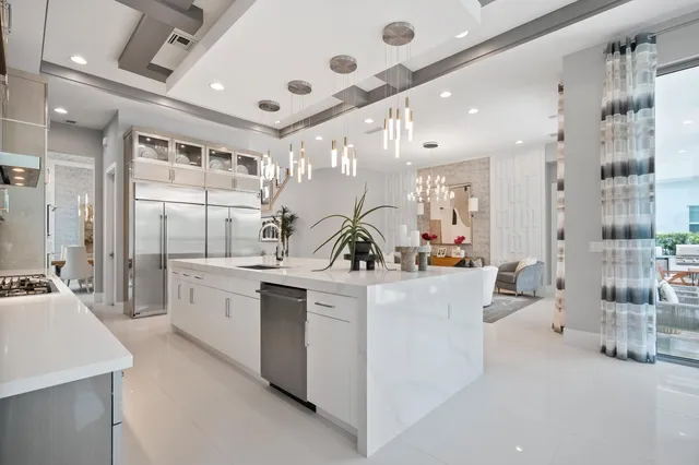 a view of a livingroom with a chandelier fan and hardwood floor
