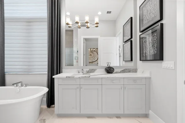 a bed room with a bed and a chandelier