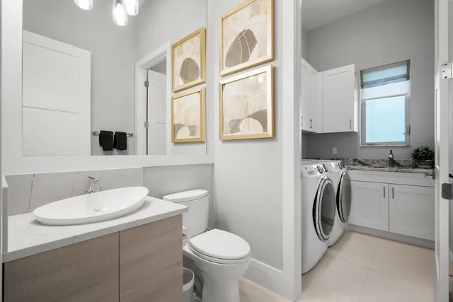 a bathroom with a sink toilet and mirror