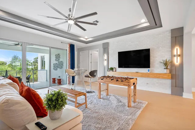 a view of a patio with table and chairs potted plants and palm tree