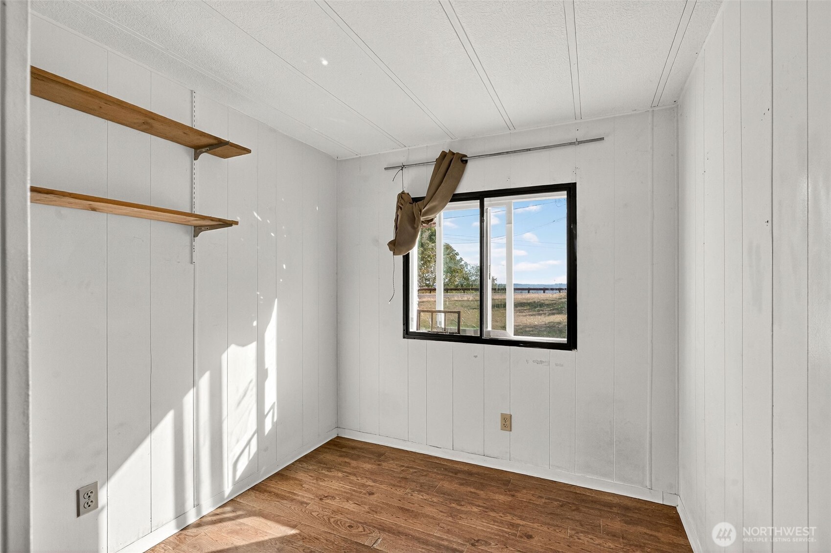 24525 59th Avenue Southwest Vashon, WA 98070 - Photo 18 of 26 a view of an empty room with a window and wooden floor