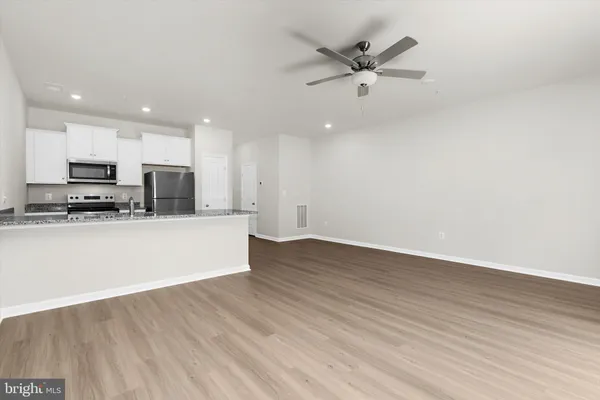 a view of a kitchen with a sink and a stove top oven