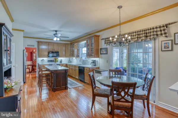 a view of a dining room with furniture wooden floor and chandelier