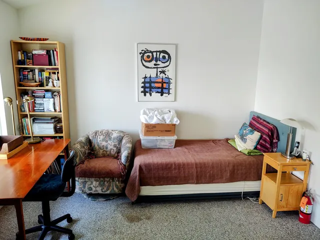 a bedroom with a bed and a couch