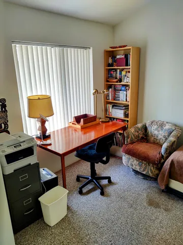 a reading room with furniture and a book shelf