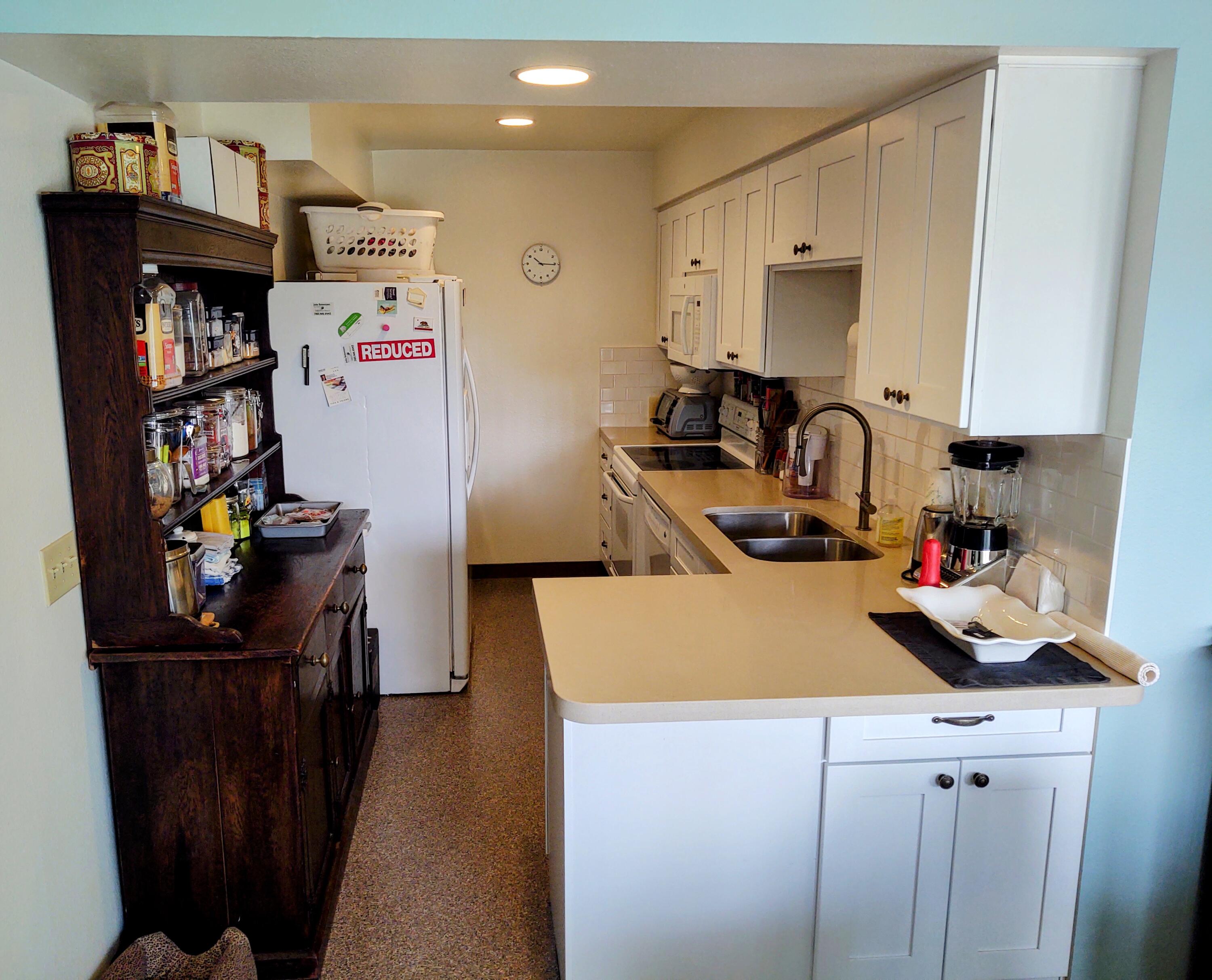 1100 East Amado Road, Unit 13B2 Palm Springs, CA 92262 - Photo 20 of 20 a kitchen with a refrigerator and a stove top oven