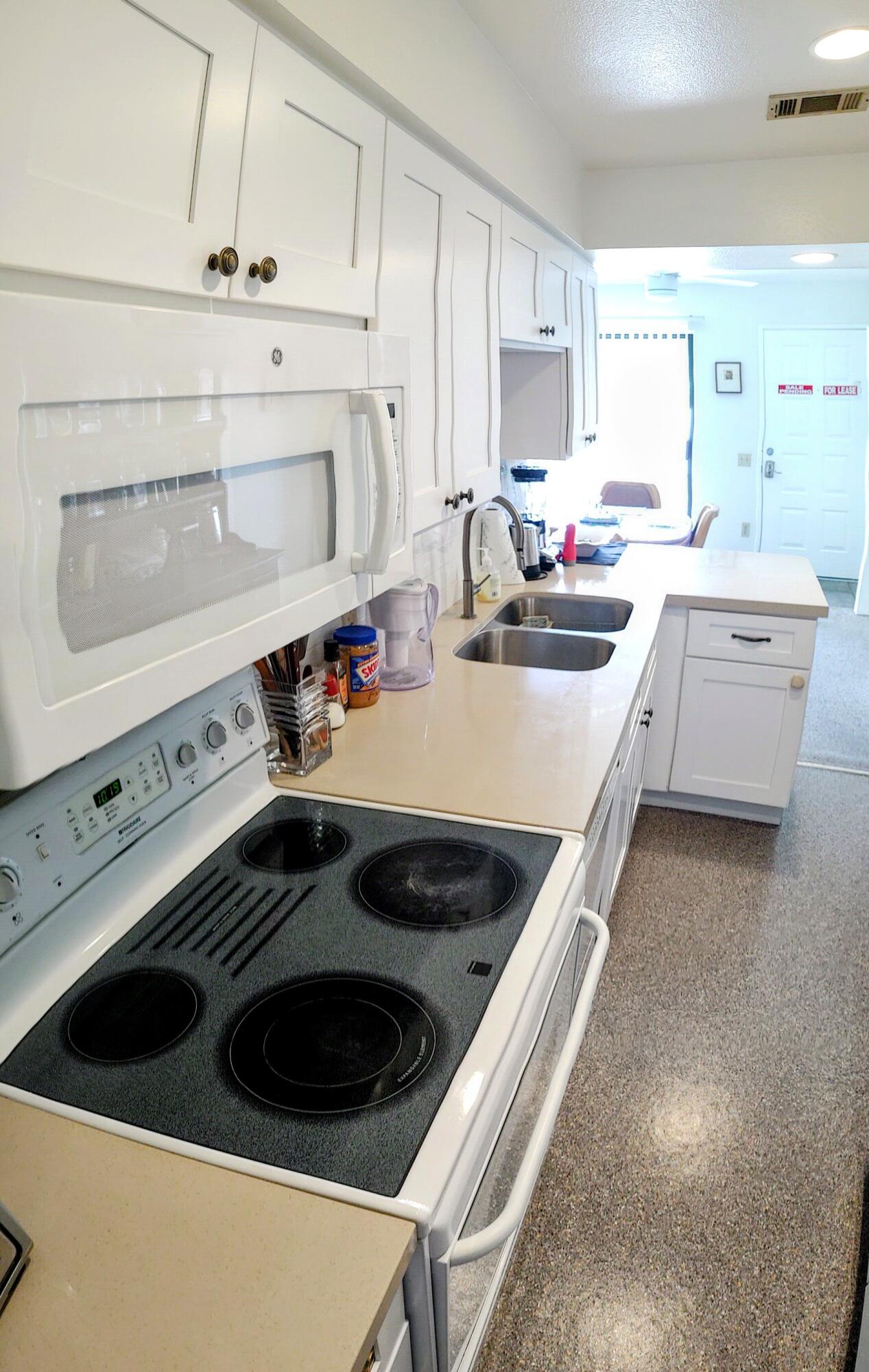 1100 East Amado Road, Unit 13B2 Palm Springs, CA 92262 - Photo 6 of 20 a kitchen with a stove and a sink