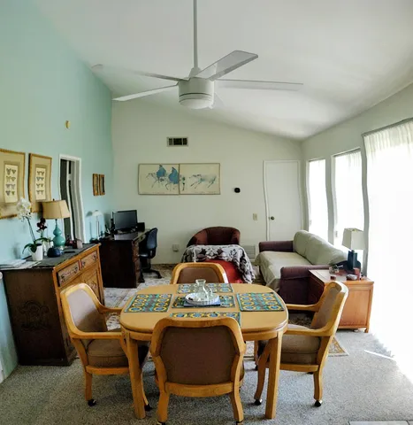 a view of a dining room with furniture window and outside view