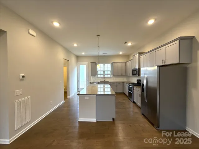 a kitchen with refrigerator cabinets and furniture