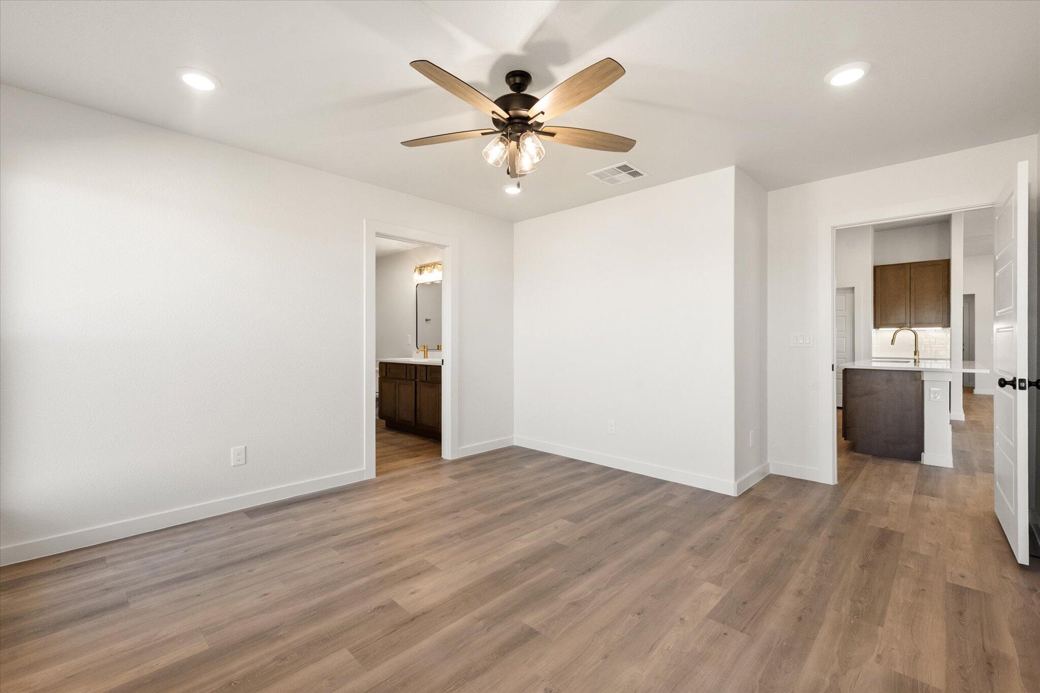 3102 138th Place Lubbock, TX 79423 - Photo 13 of 21 wooden floor in an empty room with a window