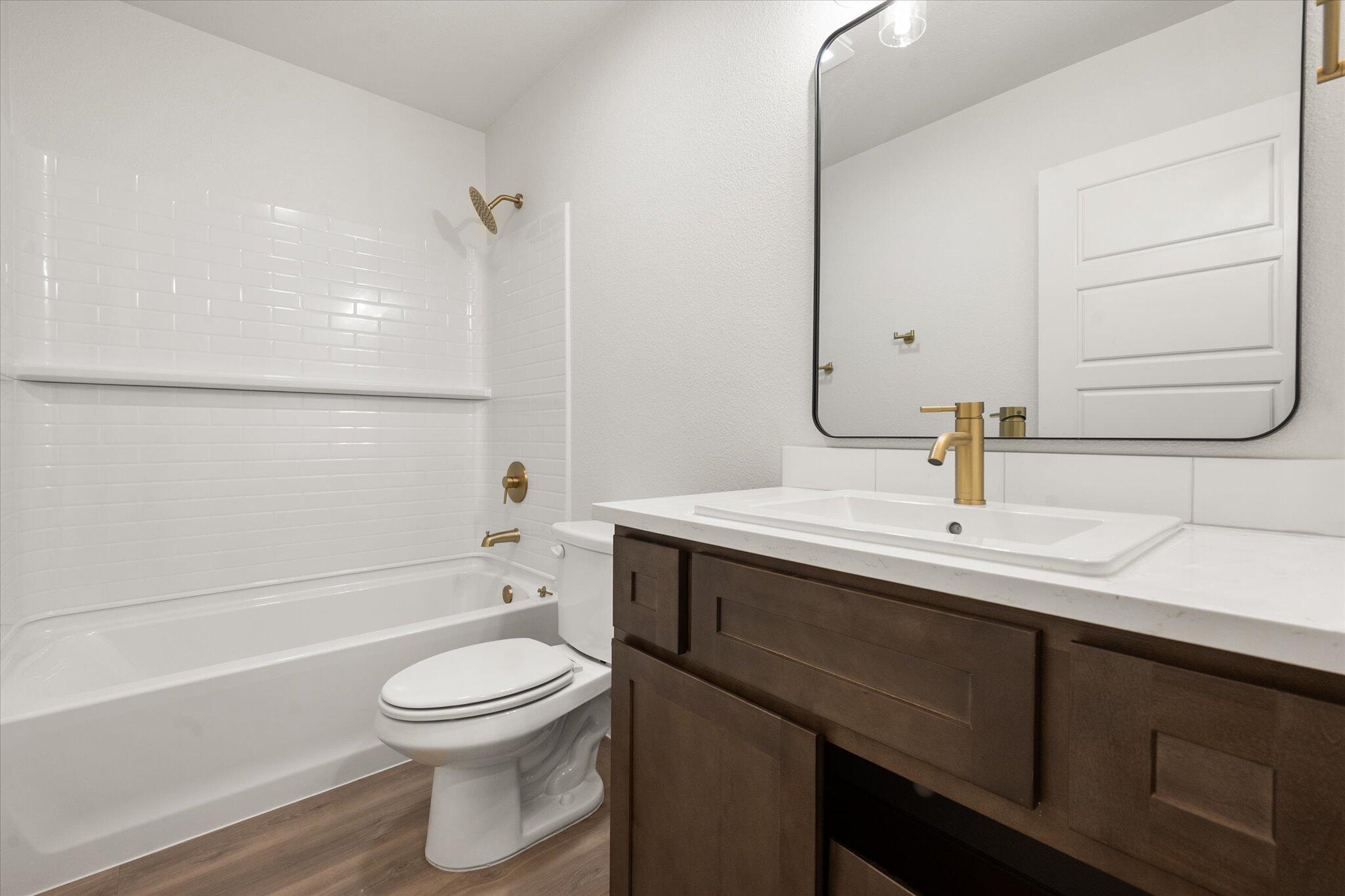 3102 138th Place Lubbock, TX 79423 - Photo 18 of 21 a bathroom with a sink a toilet and shower