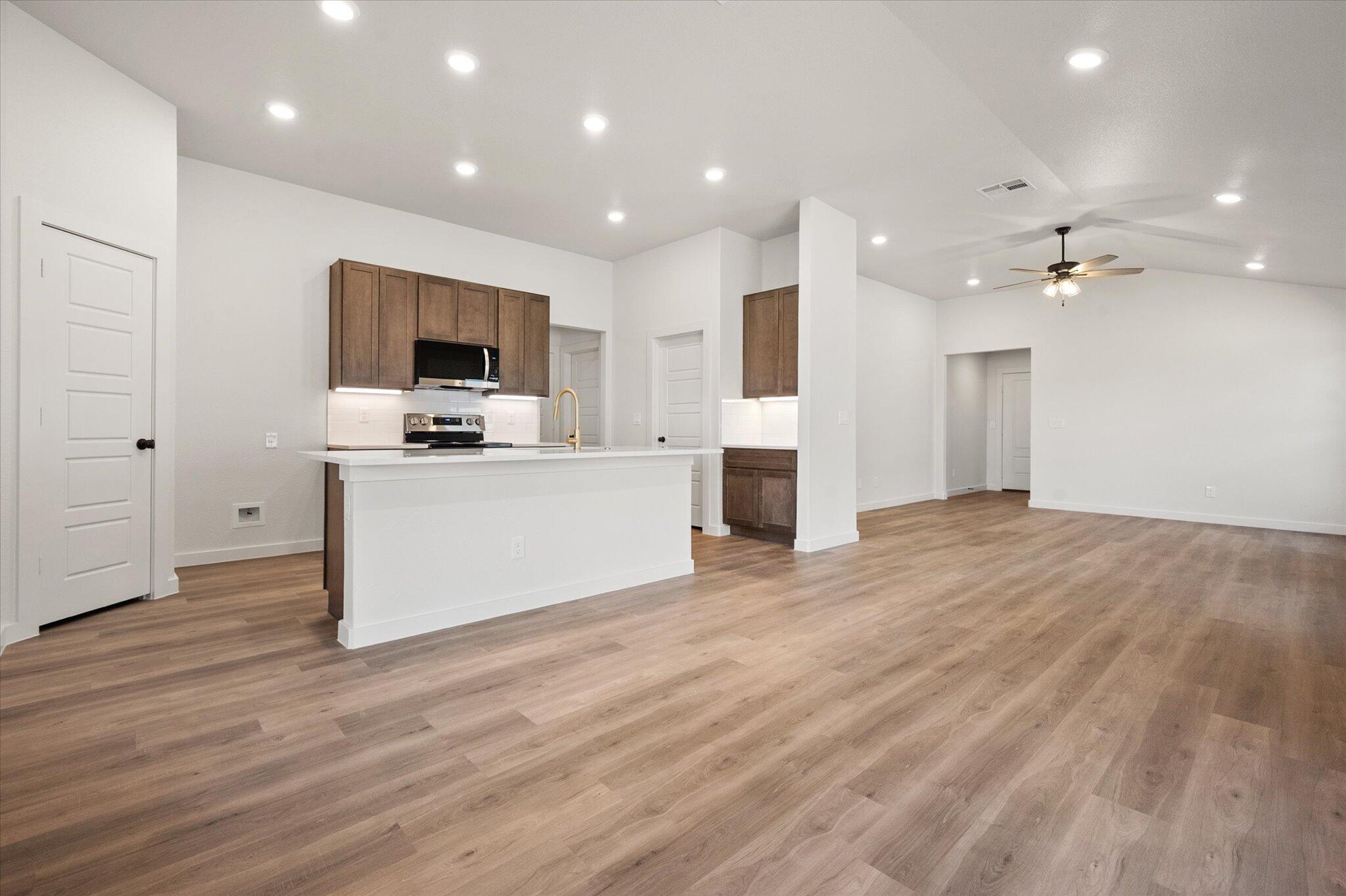 3102 138th Place Lubbock, TX 79423 - Photo 6 of 21 a view of kitchen with cabinets microwave and stove