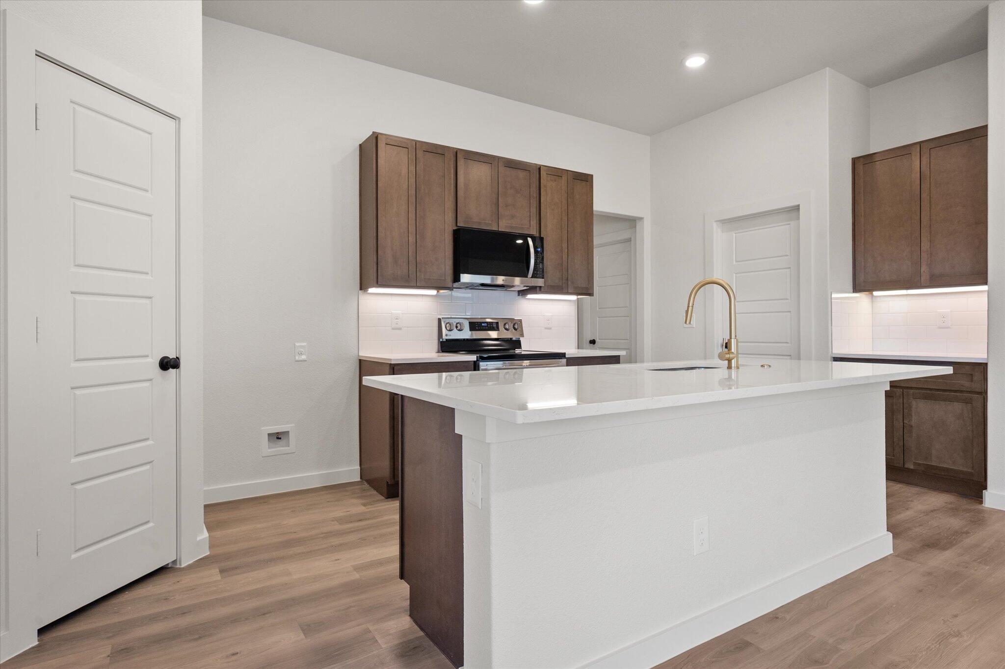 3102 138th Place Lubbock, TX 79423 - Photo 7 of 21 a kitchen with a refrigerator and a sink