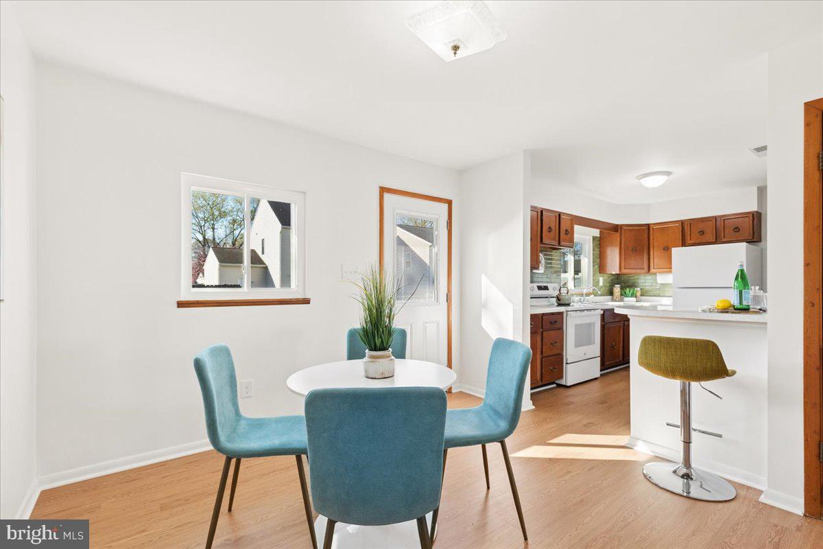 723 207th Street Pasadena, MD 21122 - Photo 11 of 42 a view of a dining room with furniture window and wooden floor