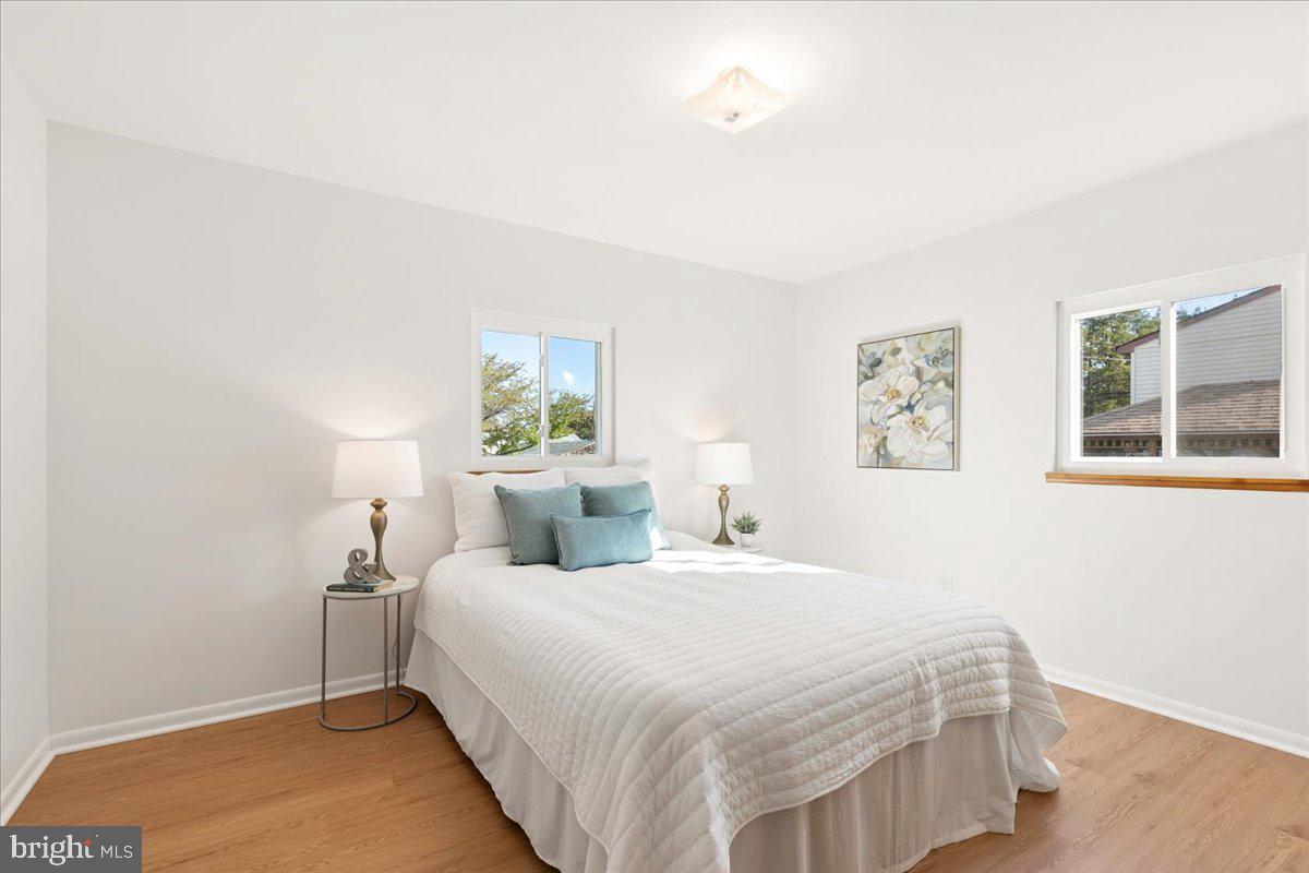 723 207th Street Pasadena, MD 21122 - Photo 17 of 42 a bedroom with a bed and a night stand