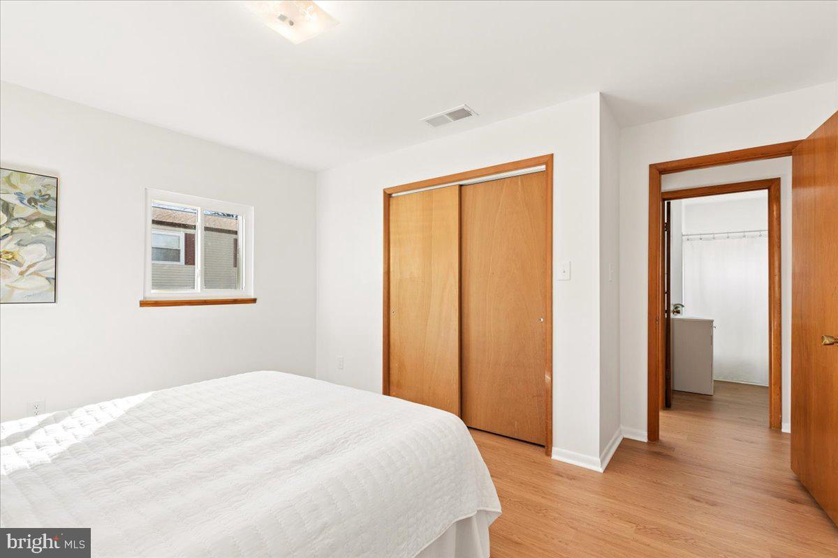 723 207th Street Pasadena, MD 21122 - Photo 18 of 42 a bedroom with a bed and wooden floor