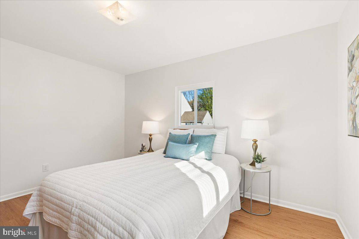 723 207th Street Pasadena, MD 21122 - Photo 19 of 42 a bedroom with a bed and a painting on the wall