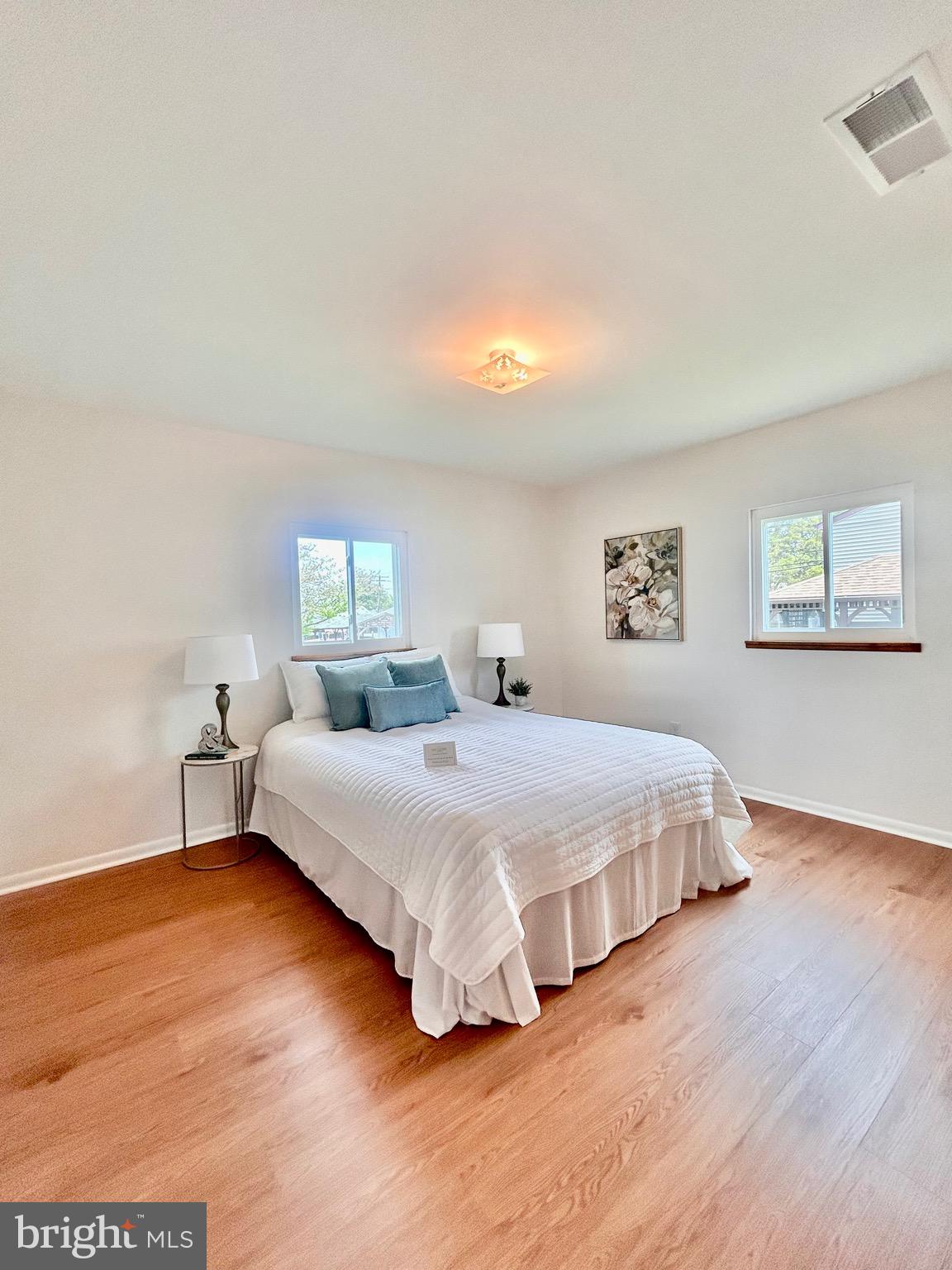 723 207th Street Pasadena, MD 21122 - Photo 22 of 42 a spacious bedroom with a bed and a night stand