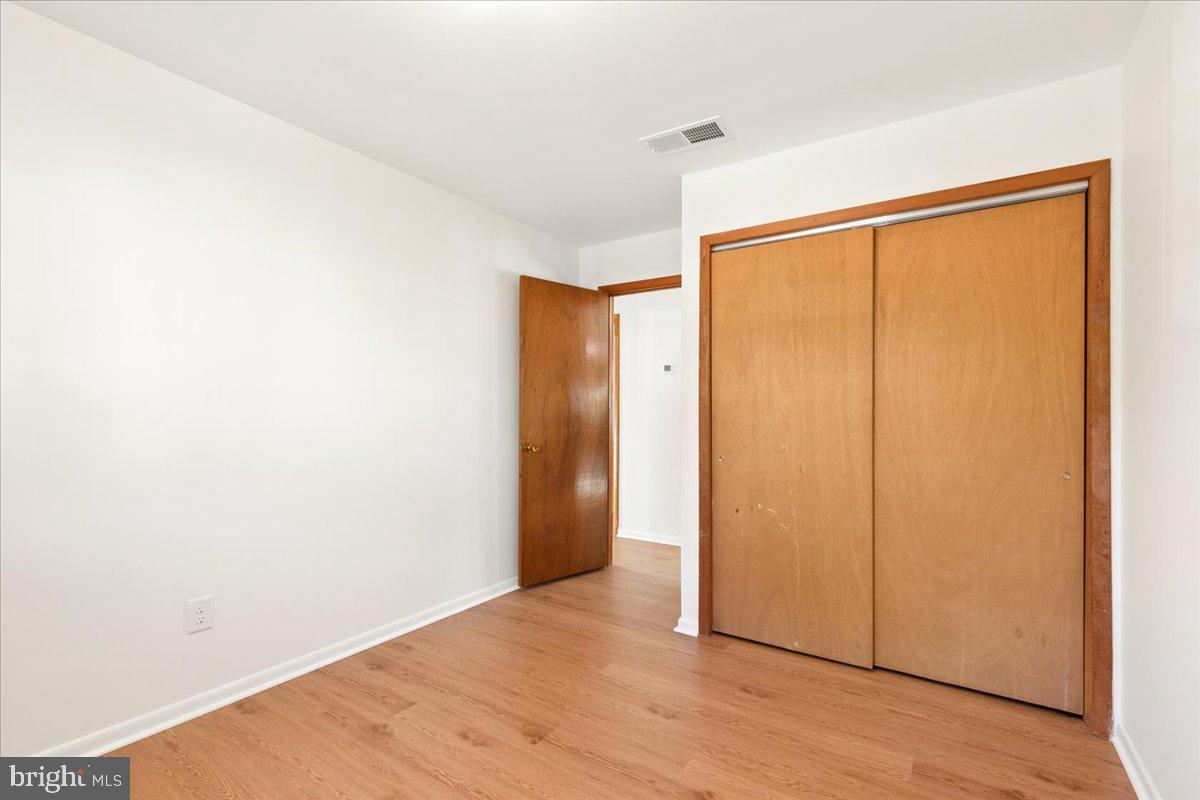 723 207th Street Pasadena, MD 21122 - Photo 25 of 42 a view of an empty room with wooden floor and a window