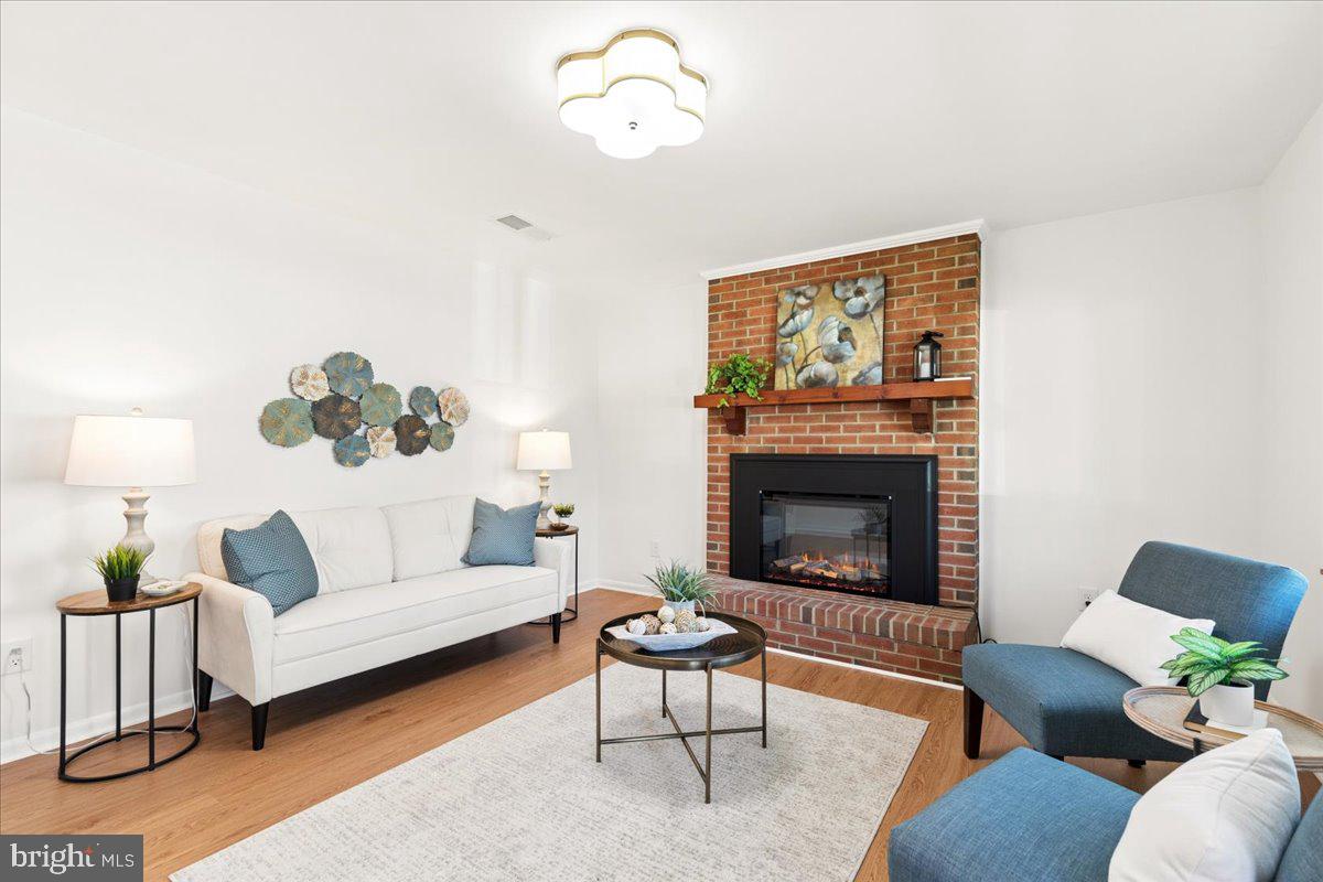 723 207th Street Pasadena, MD 21122 - Photo 3 of 42 a living room with furniture and a fireplace