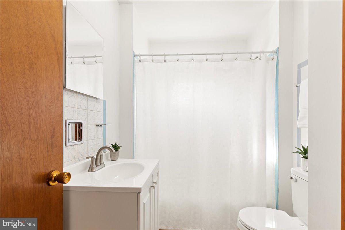 723 207th Street Pasadena, MD 21122 - Photo 31 of 42 a bathroom with a sink toilet and shower
