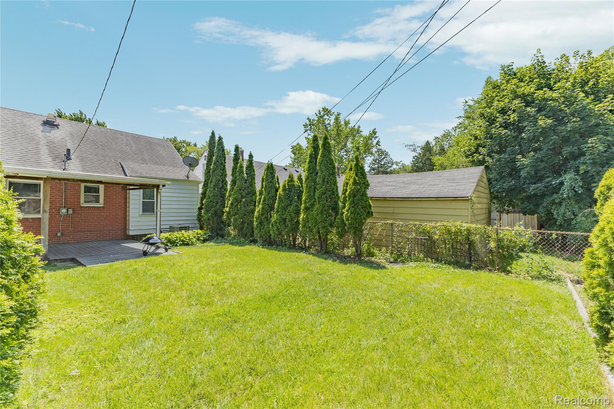 26508 Five Mile Road Redford, MI 48239 - Photo 38 of 41 Expansive green lawn with mature evergreen trees bordering the property