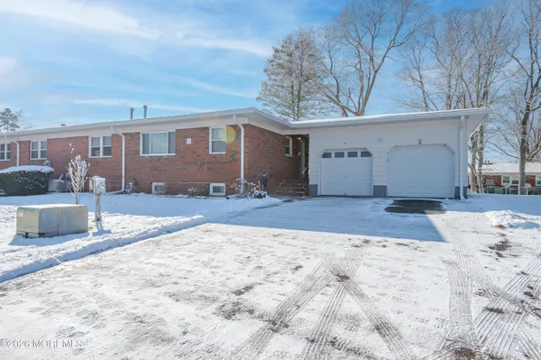 a view of a house with a yard covered in snow