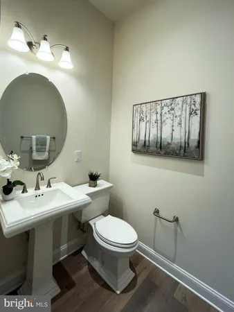 a bathroom with a toilet a sink and mirror
