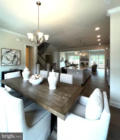 a view of a dining room with furniture a chandelier and wooden floor