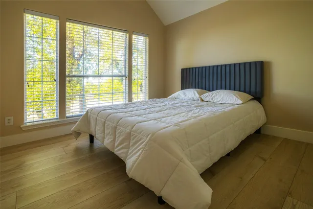 a bed sitting in a bedroom next to a window