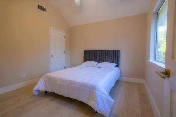 a bedroom with a bed and window