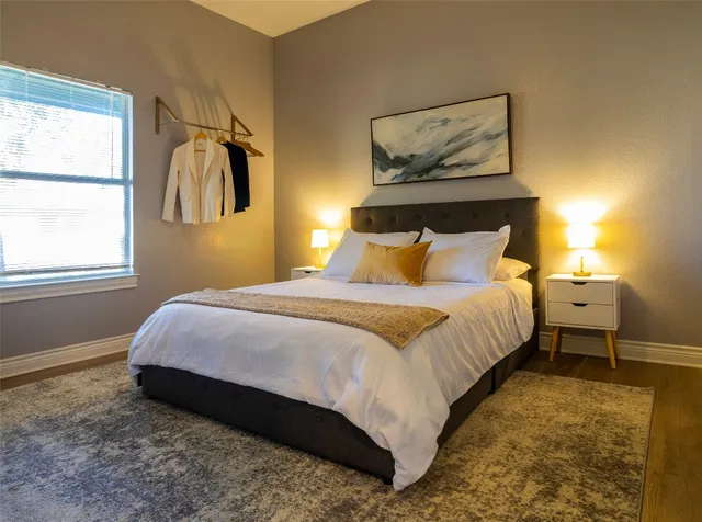 a bedroom with a bed and a painting on the wall