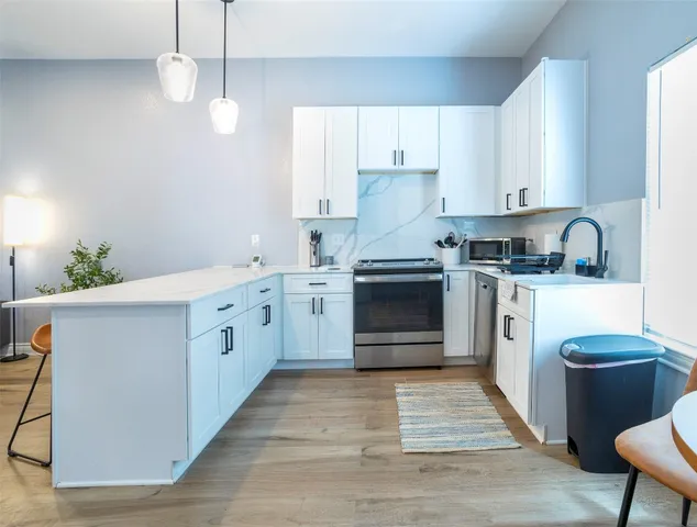 a kitchen with a stove sink and cabinets