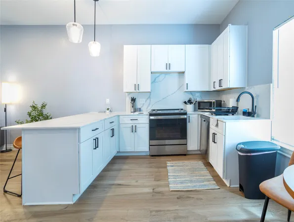 a kitchen with a stove sink and cabinets