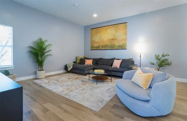 a living room with furniture and a potted plant