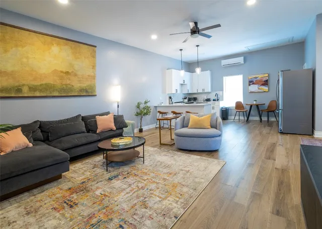 a living room with furniture and wooden floor