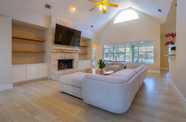 a living room with fireplace furniture and a flat screen tv