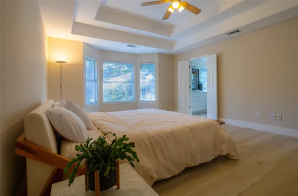 a bedroom with a bed and a chandelier