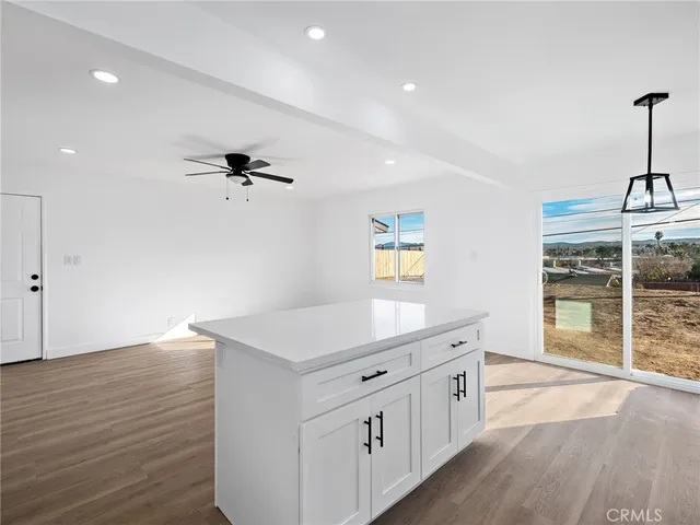 a kitchen with a wooden floor and window