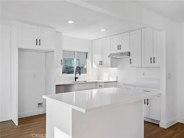 a sink with white cabinets