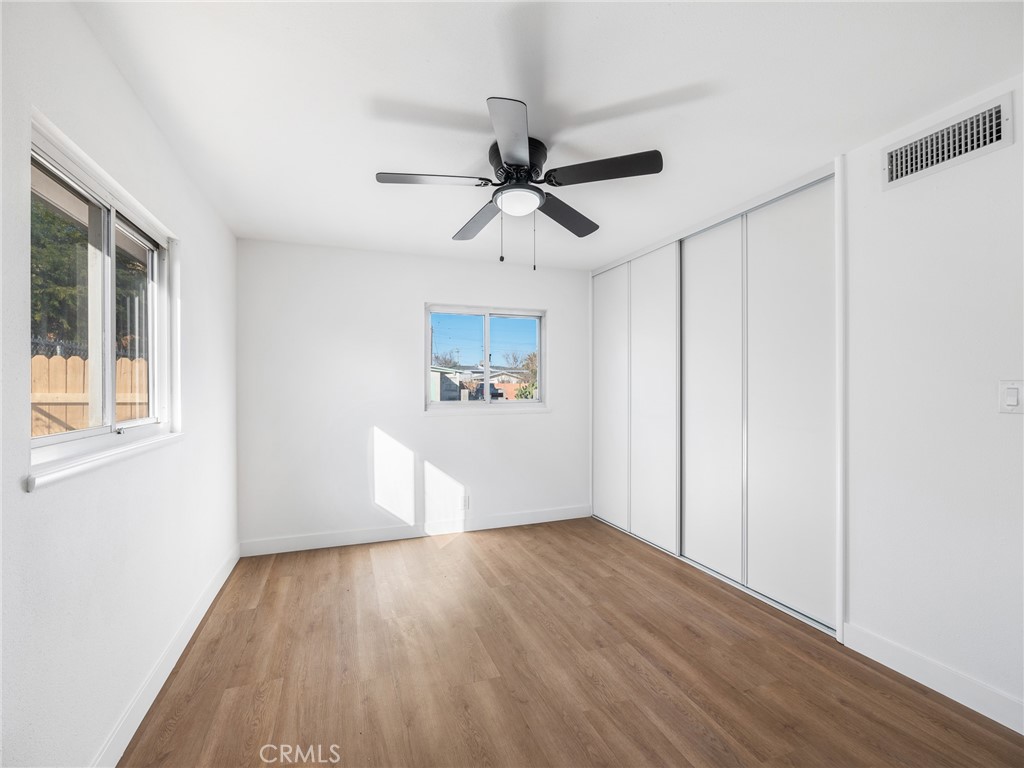 840 East Virginia Way Barstow, CA 92311 - Photo 25 of 35 a view of a hallway with wooden floor and a chandelier fan