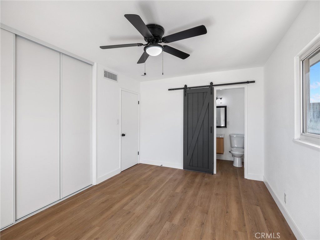 840 East Virginia Way Barstow, CA 92311 - Photo 26 of 35 a view of empty room with wooden floor and ceiling fan