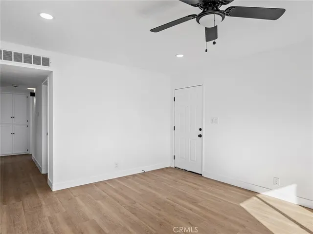 a view of a room with a sink and wooden floor